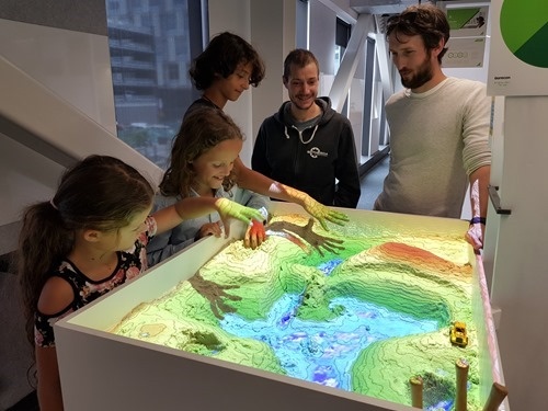 The kids playing with the AR Sandbox at Aurecon The kids playing with the AR Sandbox at Aurecon