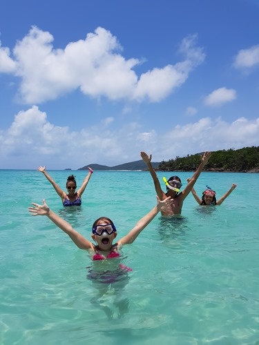 The family in the water at Whitehaven Beach The family in the water at Whitehaven Beach