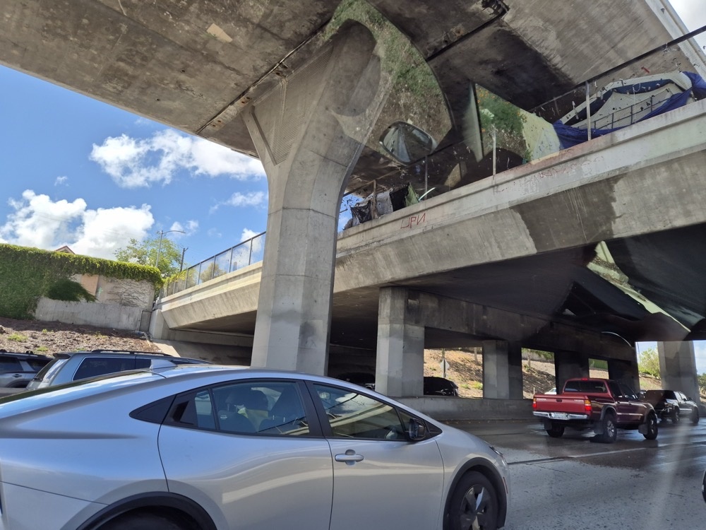 Tents under a highway bridge Tents under a highway bridge